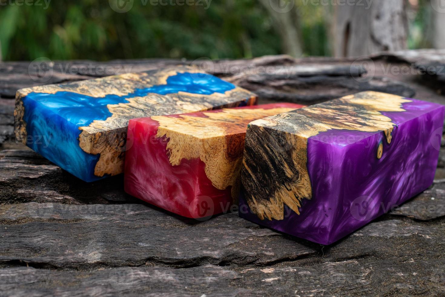 Casting epoxy resin burl wood cube on old table art background photo