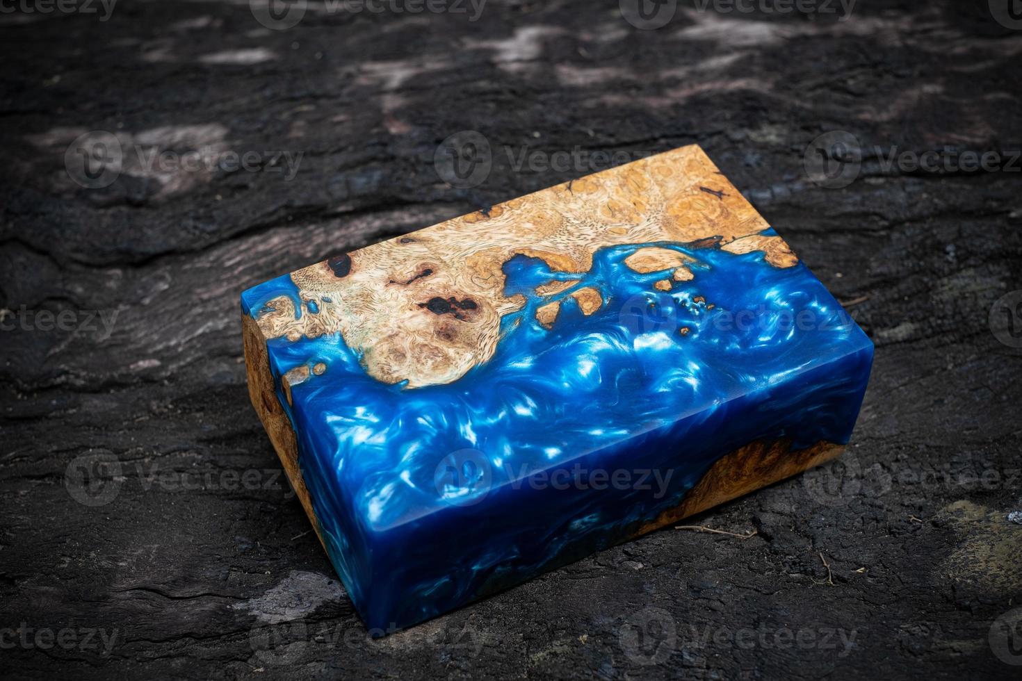 Casting epoxy resin maple burl wood on the table photo