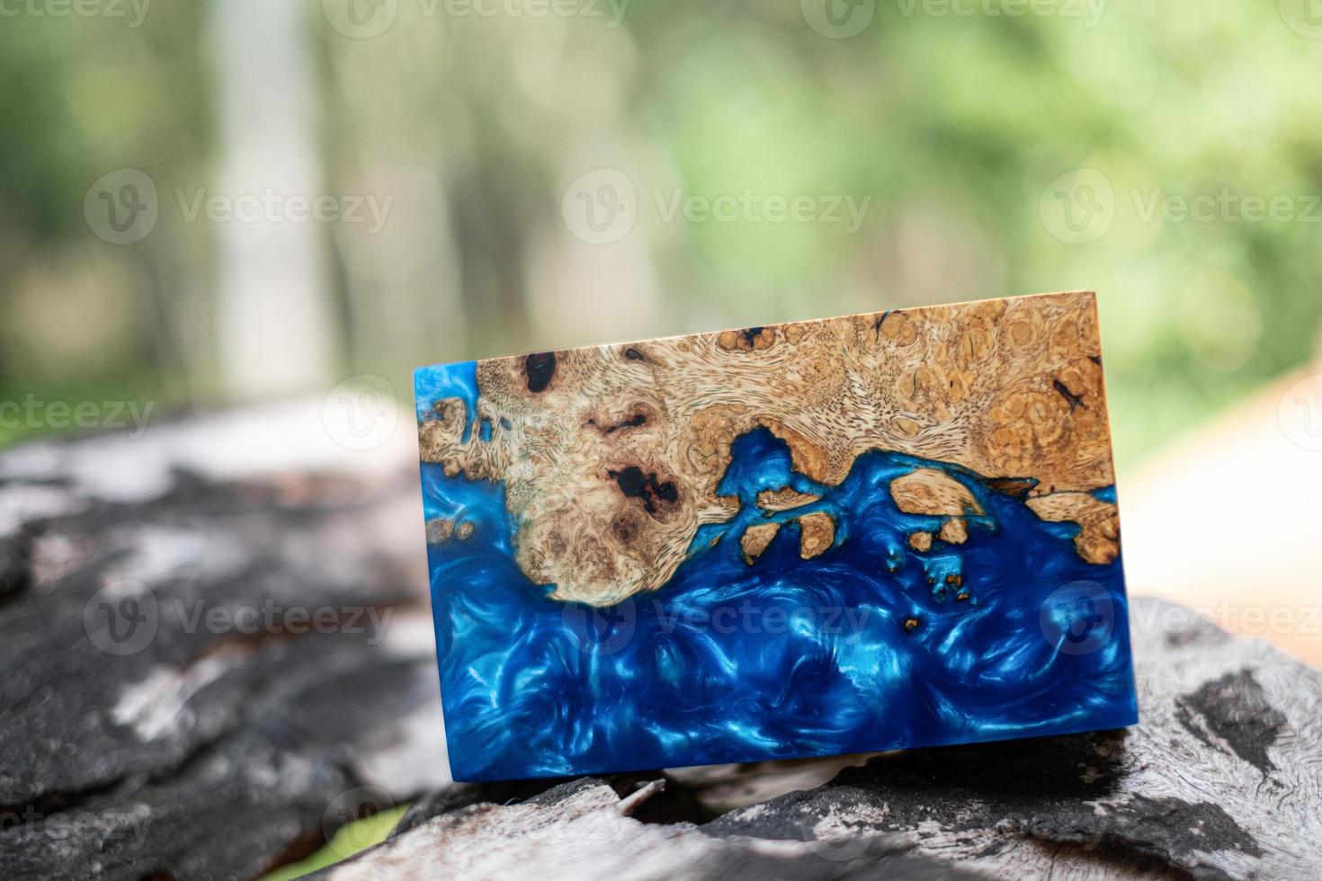 Casting epoxy resin maple burl wood on the table photo