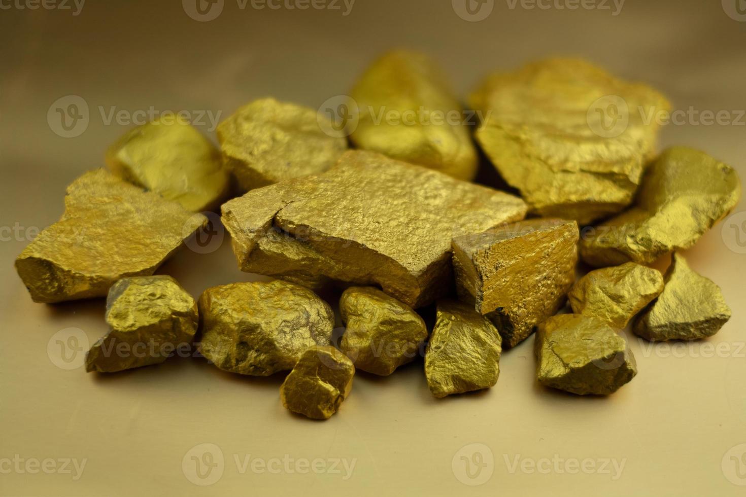 Group fo gold nugget at the golden background photo