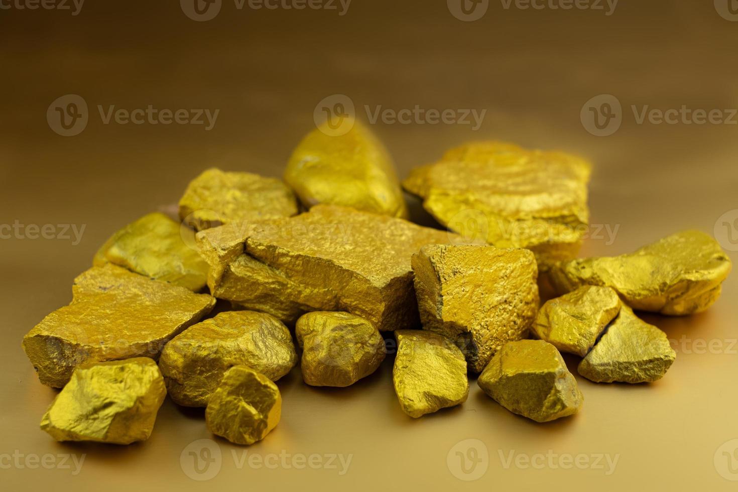 Group fo gold nugget at the golden background photo