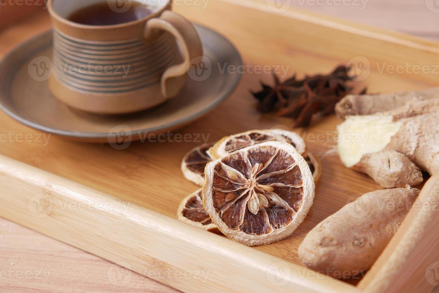 close up of dry lemon, ginger and green tea on table photo