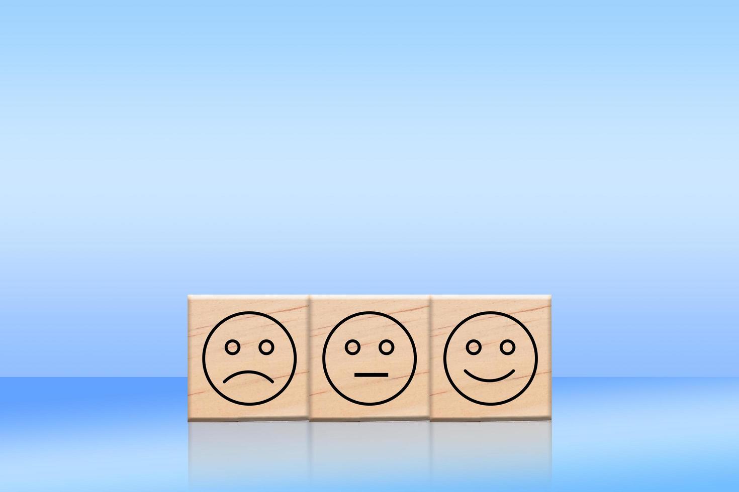 Wooden cube blocks with an emotion face symbol. Business uses a happy face on wood to represent service rating, ranking, customer review, satisfaction, and feedback. photo