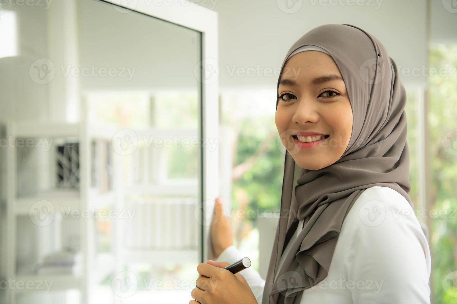 Arabic businesswoman wearing hijab Work in the office photo