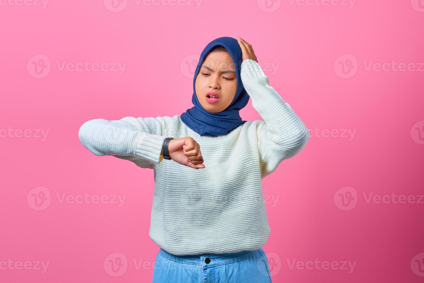 Portrait of young Asian woman worried work deadline stress on pink background photo