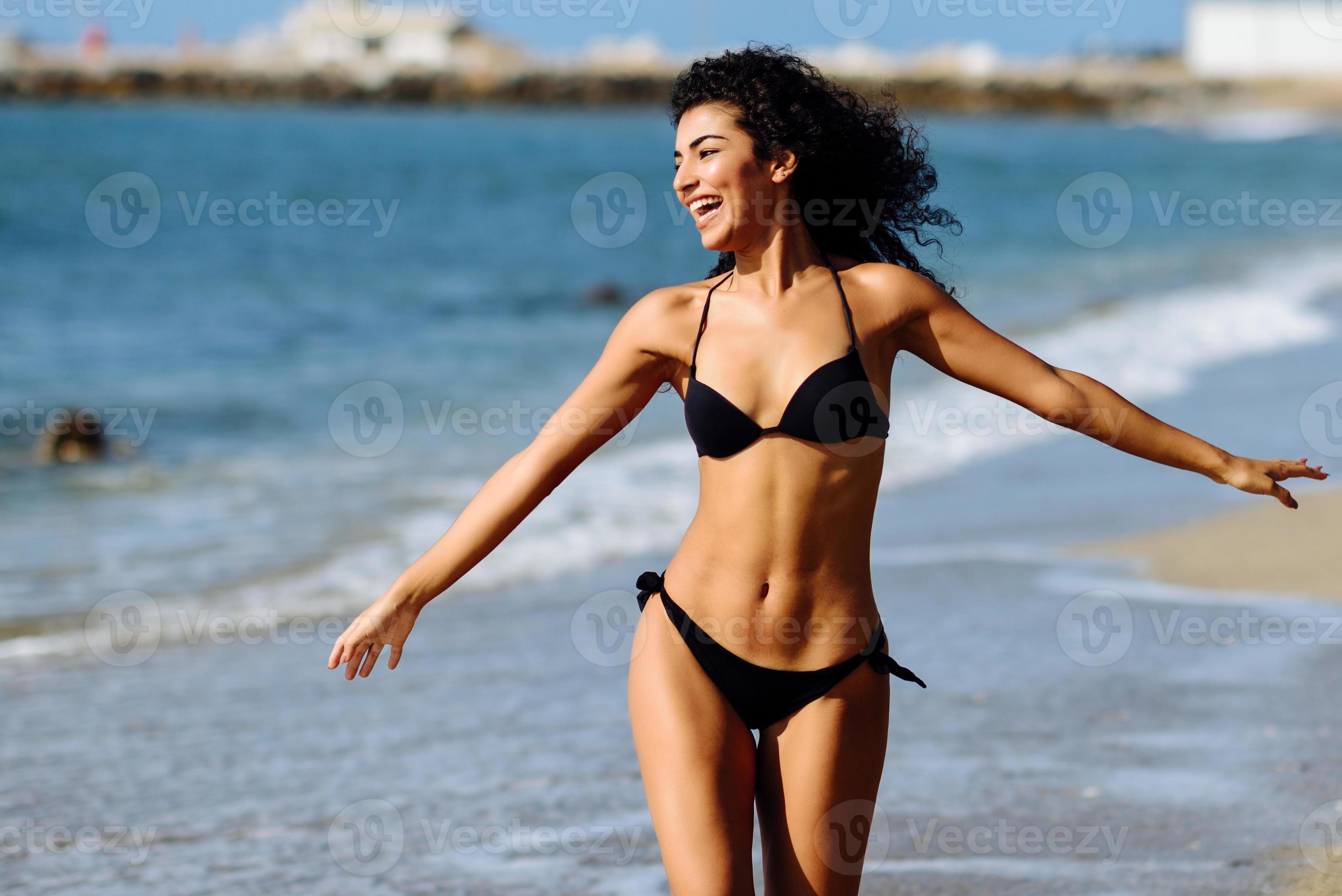 Young arabic woman with beautiful body in swimwear smiling on a tropical  beach. - a Royalty Free Stock Photo from Photocase