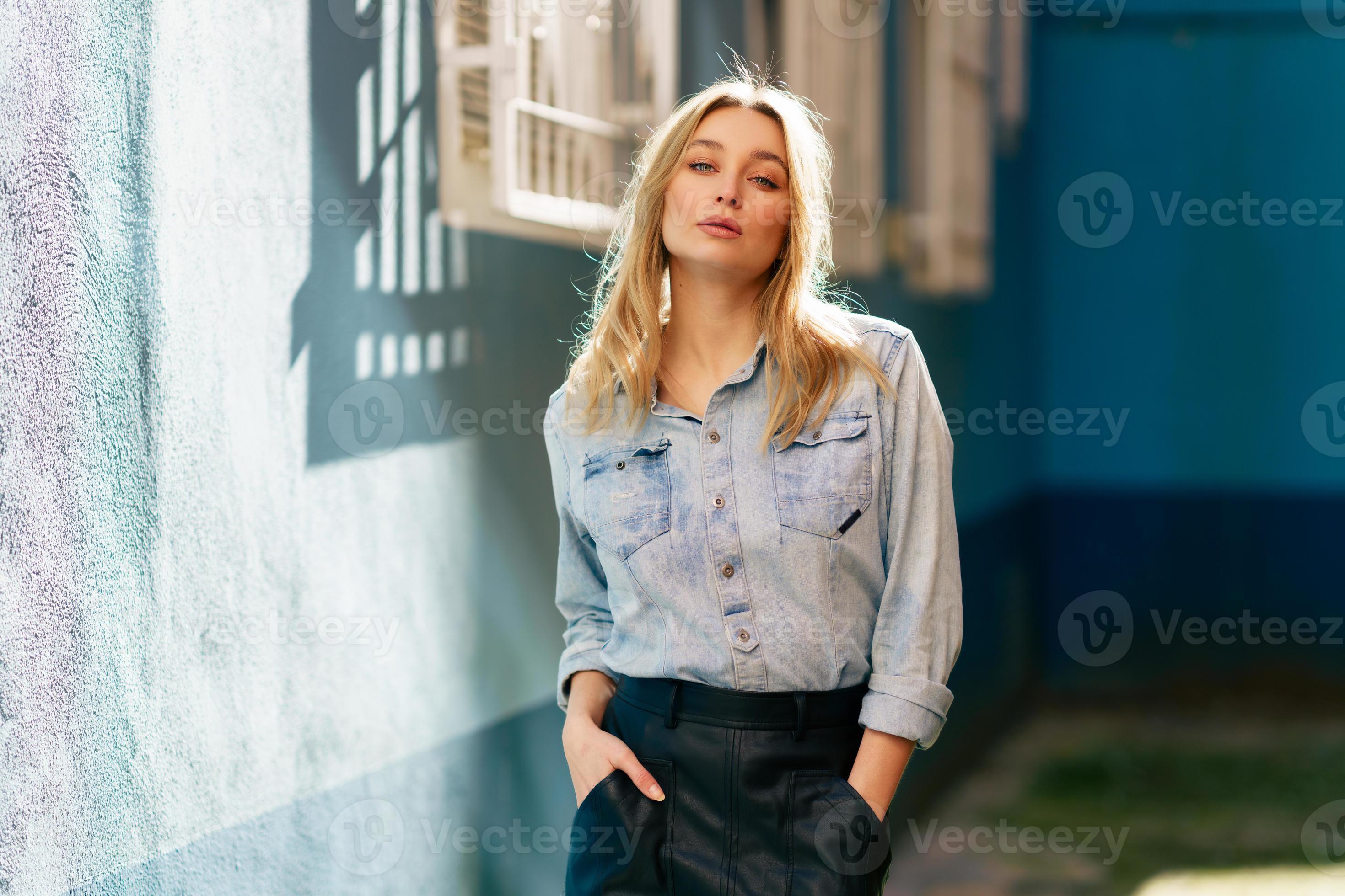 Blonde woman wearing denim shirt and picture