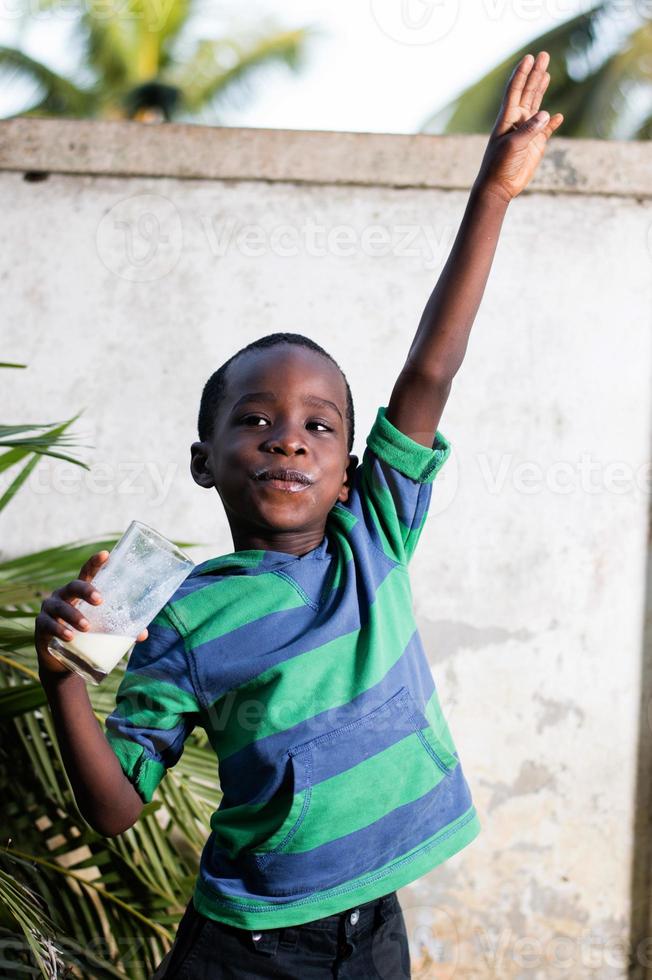 happy child holding a glass of milk. photo