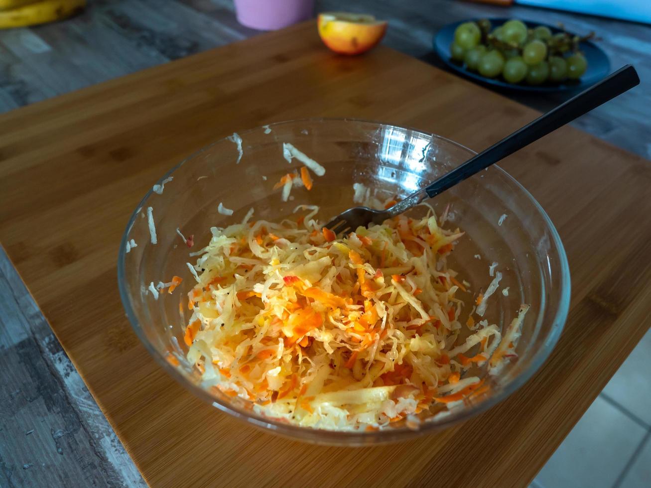 Carrots with cabbage in a glass bowl, side view photo