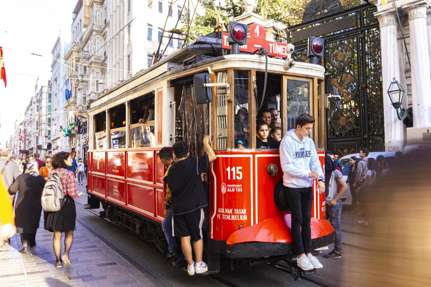 ISTANBUL, TURKEY, NOVEMBER 9, 2019 - Unidentified people by Istanbul nostalgic tramway in Istanbul, Turkey. In Istanbul there are are two tramlines with heritage streetcars. photo