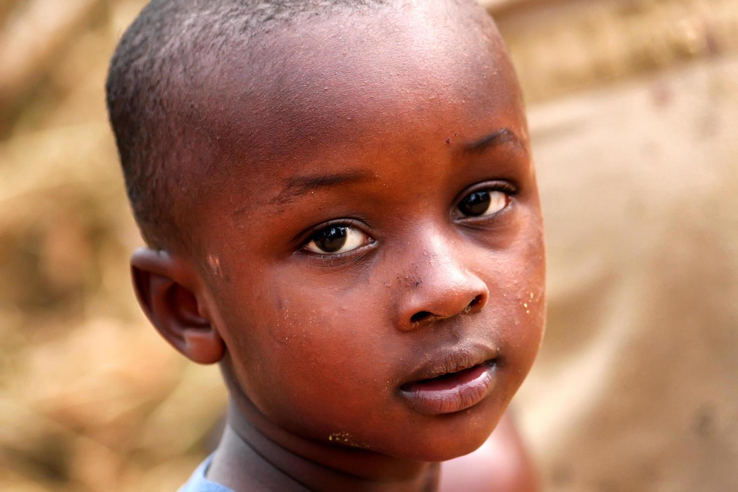 MAYANGE, RWANDA, JANUARY 6, 2012 - Unidentified boy from the UN Millenium village at January 6, 2012. It is a village of returnees-who came back to Rwanda after the 1994 genocide. photo