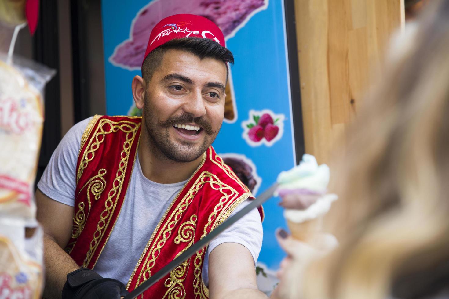 ISTANBUL, TURKEY, JUNE 15, 2019 - Unidentified seller of Turkish ice cream at Istanbul, Turkey. Traditional Turkish ice cream was made with salep, produced by orchid flowers. photo