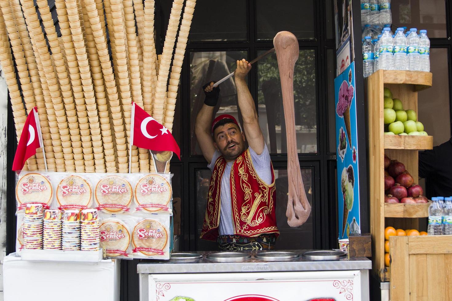 ISTANBUL, TURKEY, JUNE 15, 2019 - Unidentified seller of Turkish ice cream at Istanbul, Turkey. Traditional Turkish ice cream was made with salep, produced by orchid flowers. photo