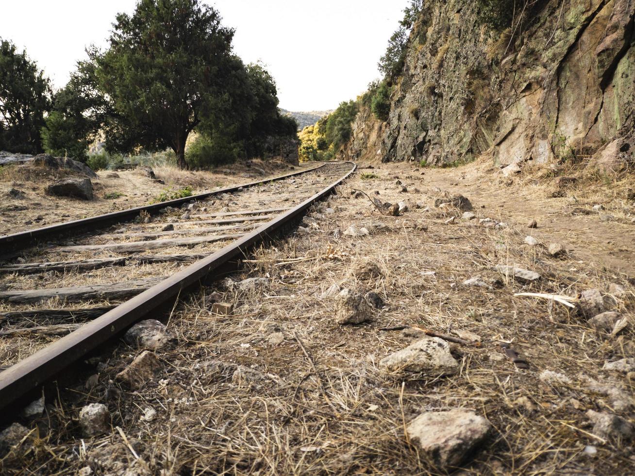 Abandoned railroad tracks through the mountains photo