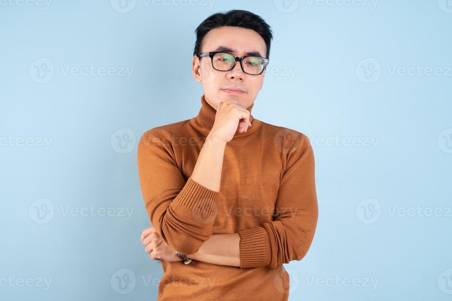 Asian man posing on blue background photo