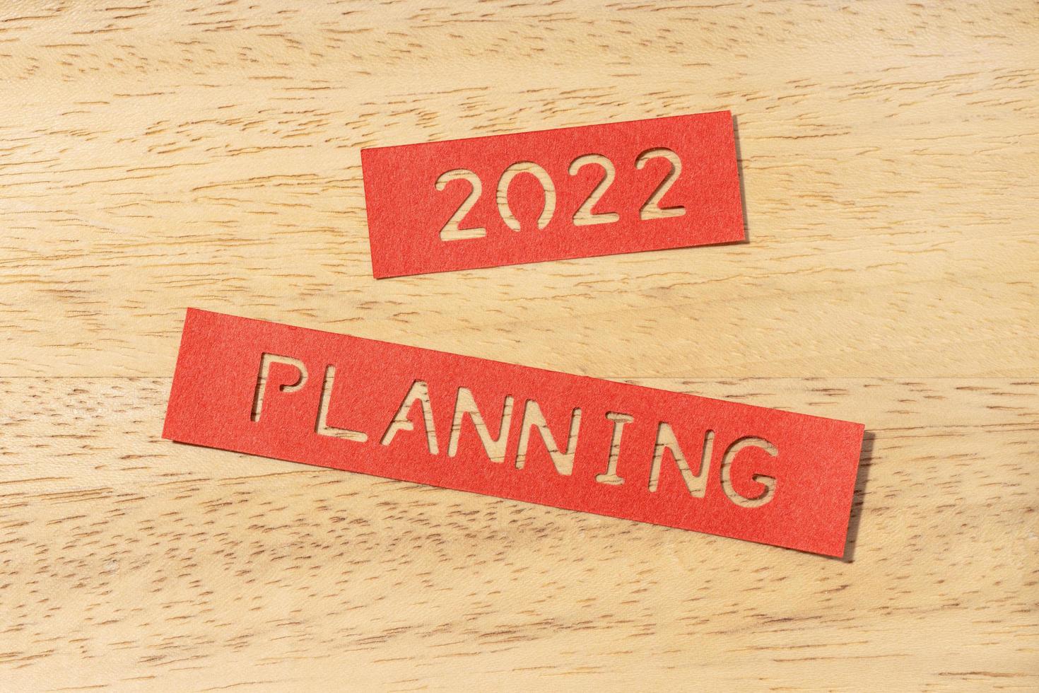 New year 2022 planning concept. Die cut Labels on wooden table photo