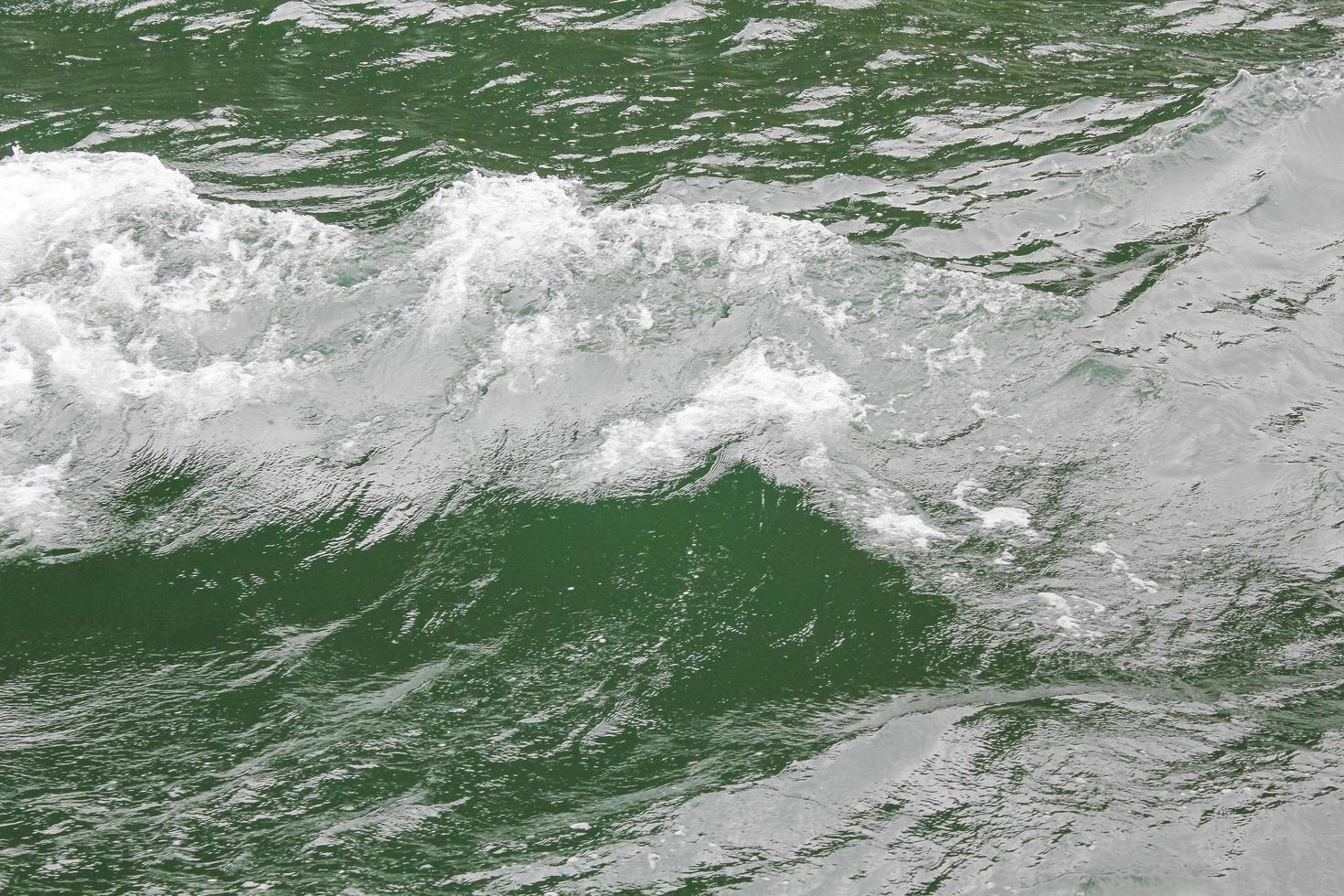 Green turquoise water with waves. Texture from above, Sognefjord Norway. photo