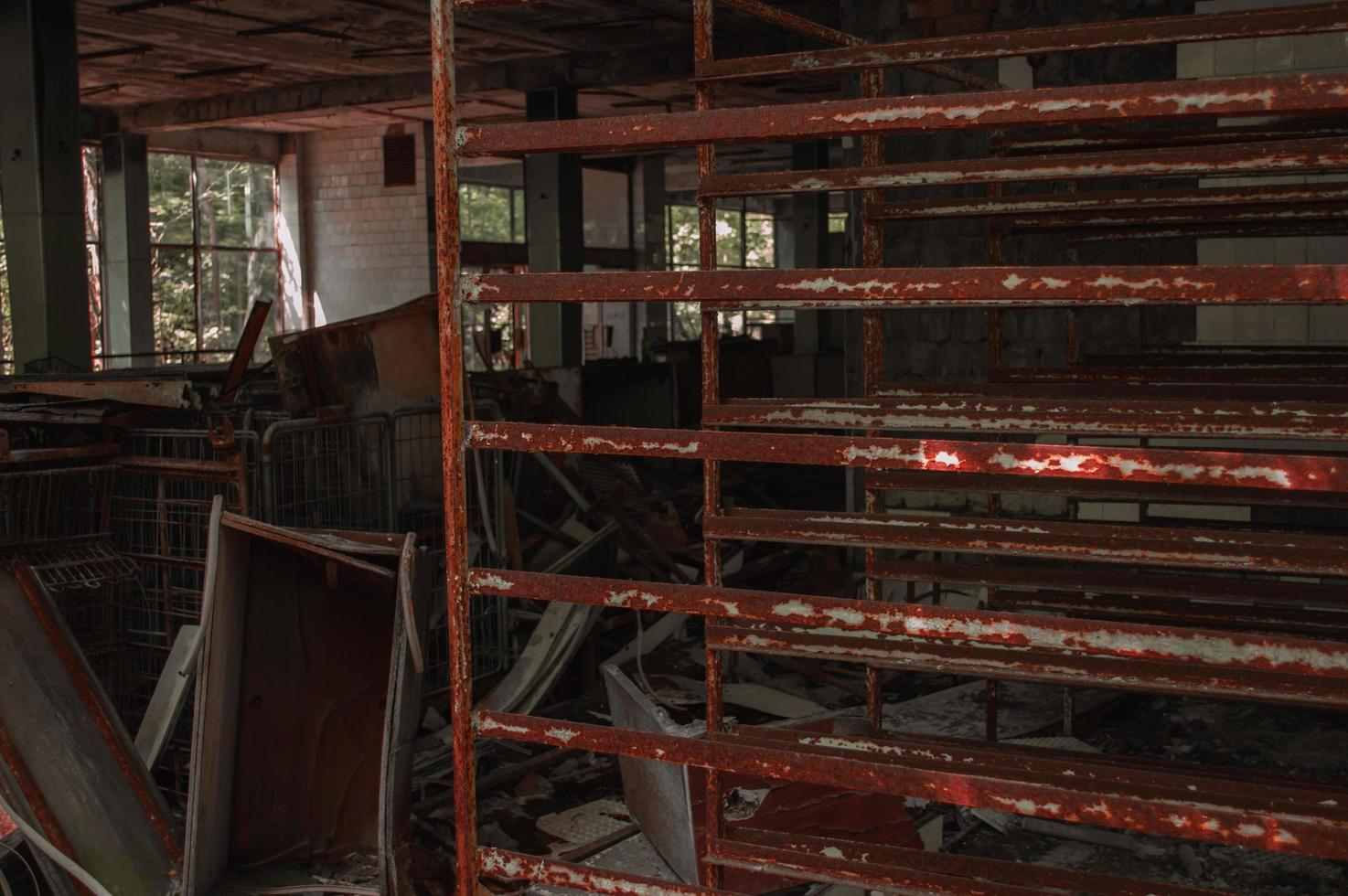 A radioactive abandoned  shop overgrown with trees in the city of Pripyat photo