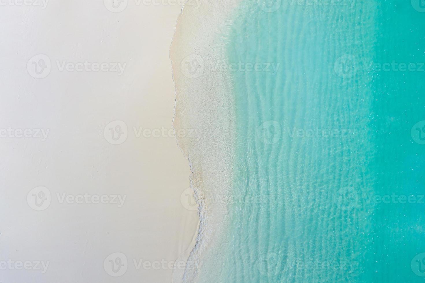 Summer seascape beautiful waves, blue sea water in sunny day. Top view from drone. Sea aerial view, amazing tropical nature background. Beautiful bright sea with waves splashing and beach sand concept photo