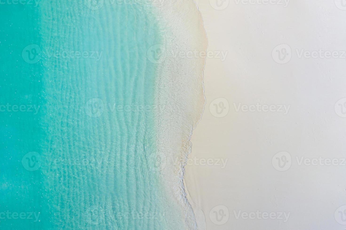 Summer seascape beautiful waves, blue sea water in sunny day. Top view from drone. Sea aerial view, amazing tropical nature background. Beautiful bright sea with waves splashing and beach sand concept photo