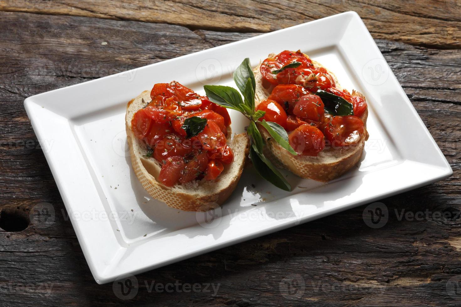 Bruschetta is an Italian antipasti made from bread, which is grilled with olive oil. photo