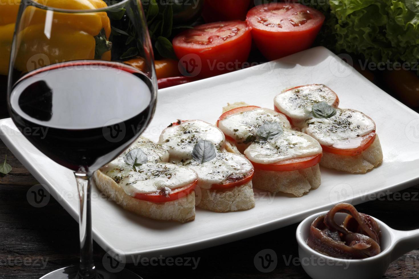 Bruschetta is an Italian antipasti made from bread, which is grilled with olive oil. photo