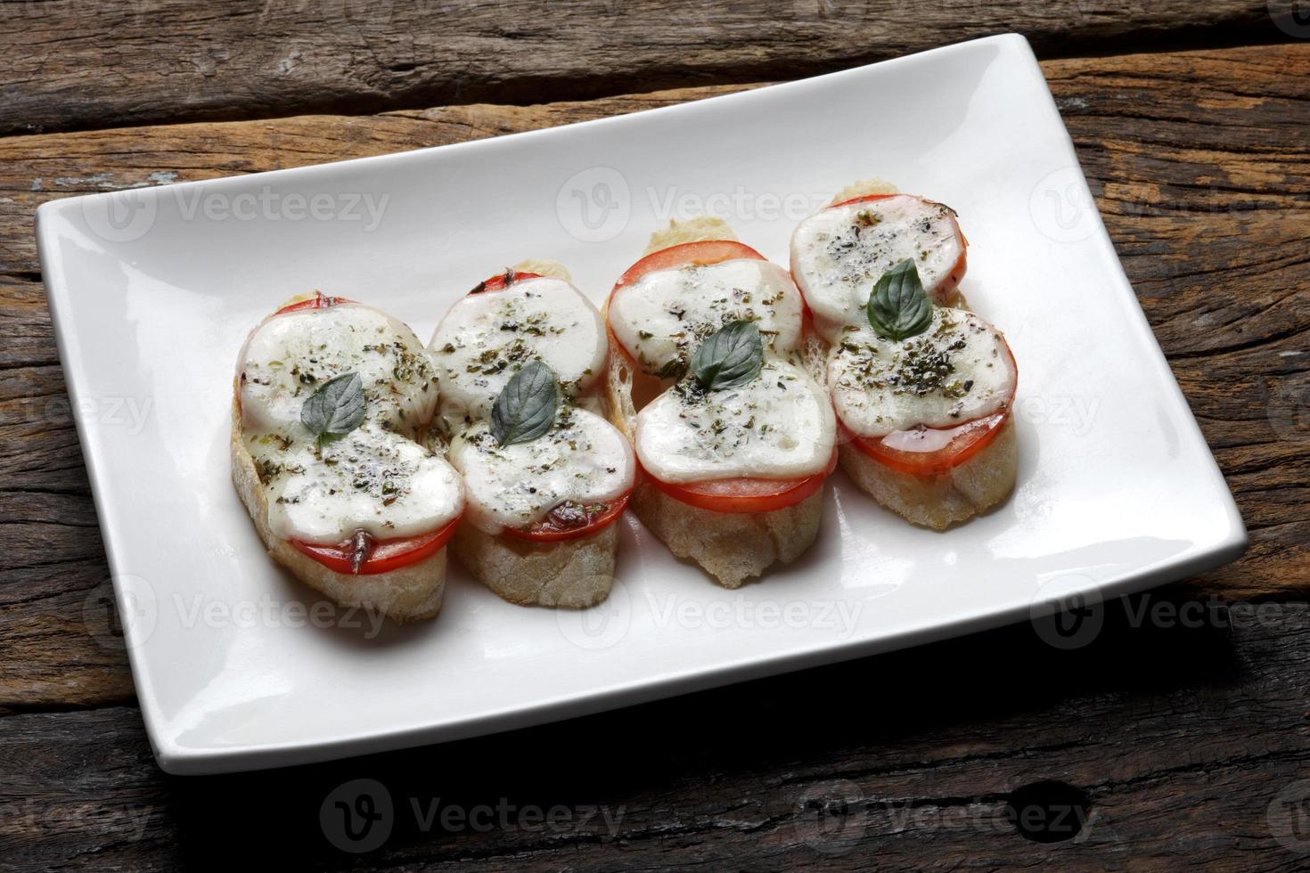 Bruschetta is an Italian antipasti made from bread, which is grilled with olive oil. photo