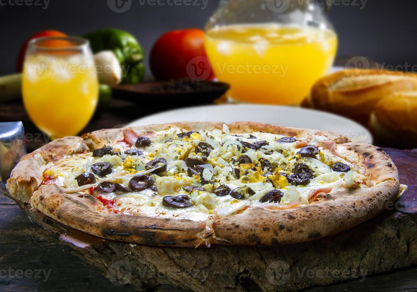 Portuguese Pizza, onion, peppers, pepperoni, egg, olive photo