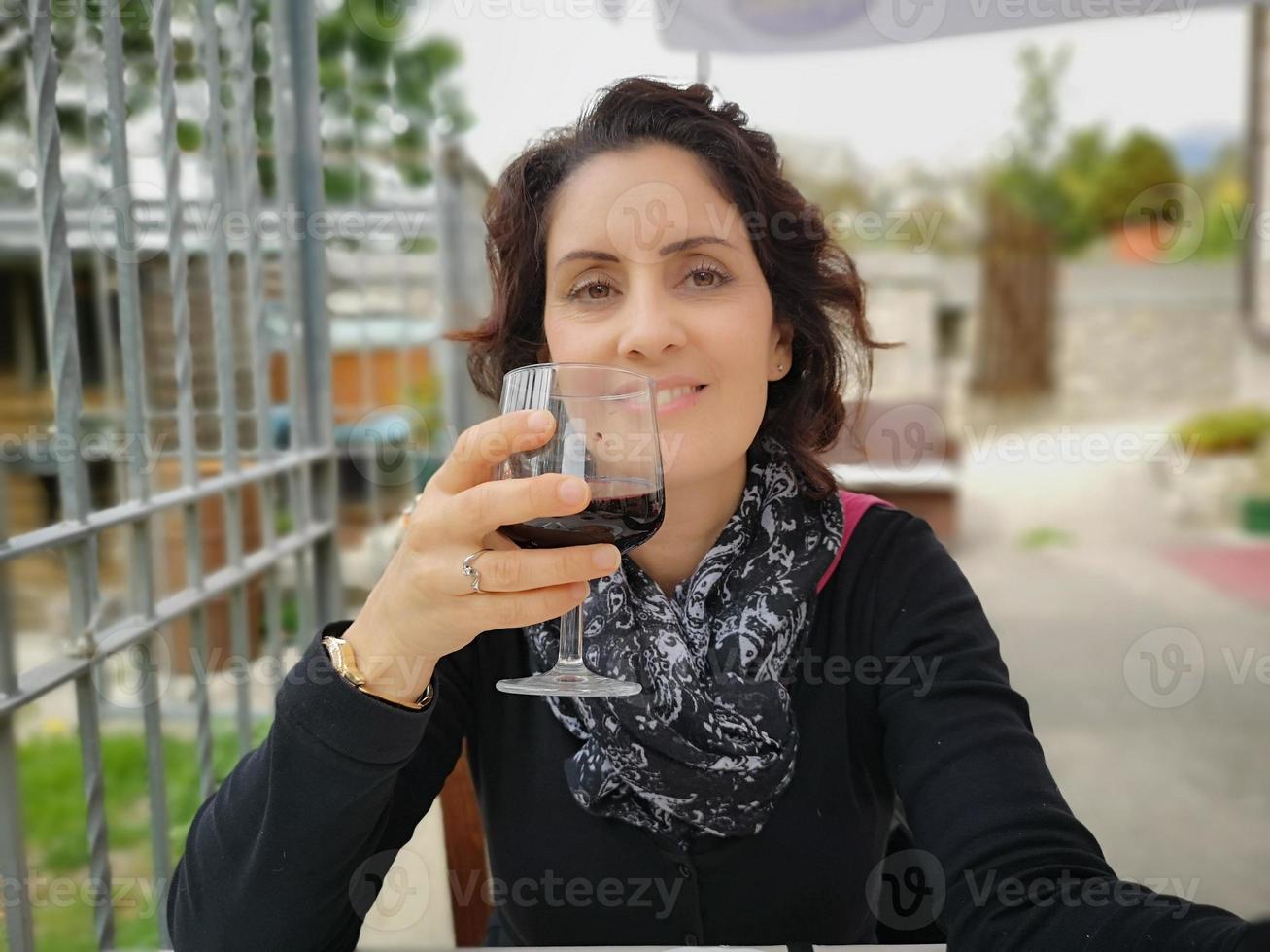 beautiful woman with glass of wine in hand photo