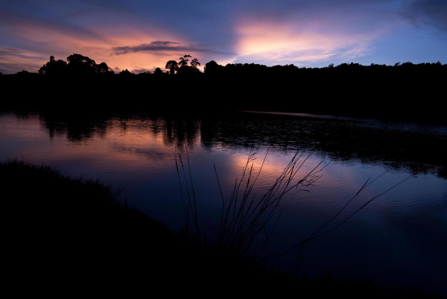 Beautiful sky landscape with sunset over river bank photo