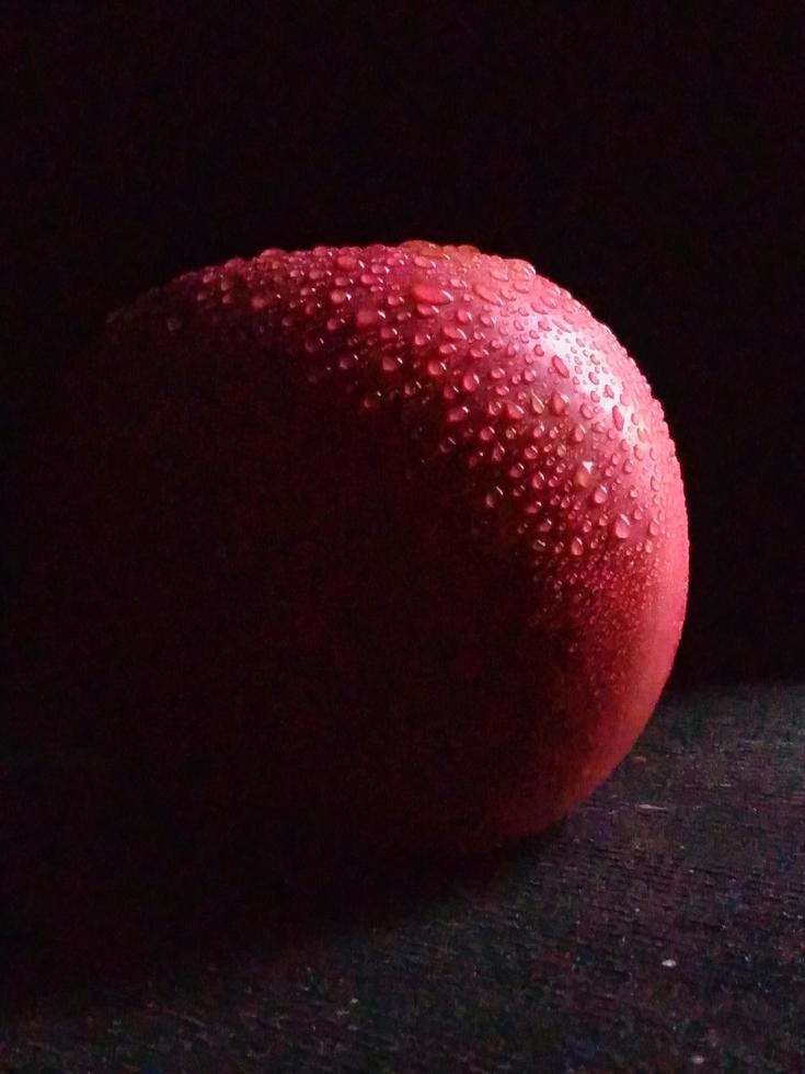 Close-up photo of fresh apples on a dark background