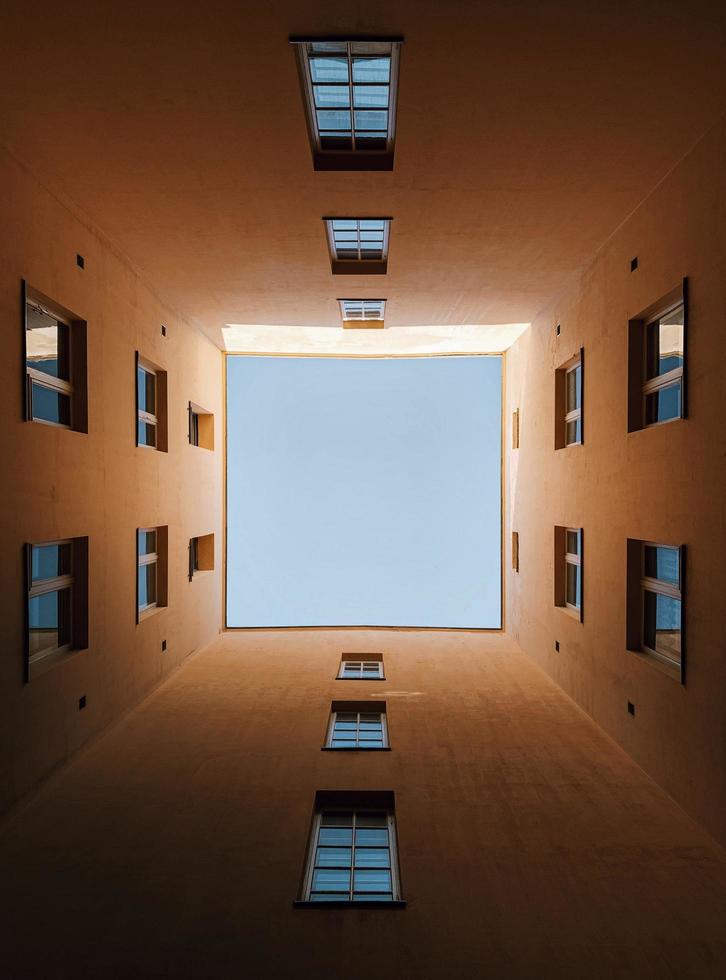 View from below looking up through buildings photo