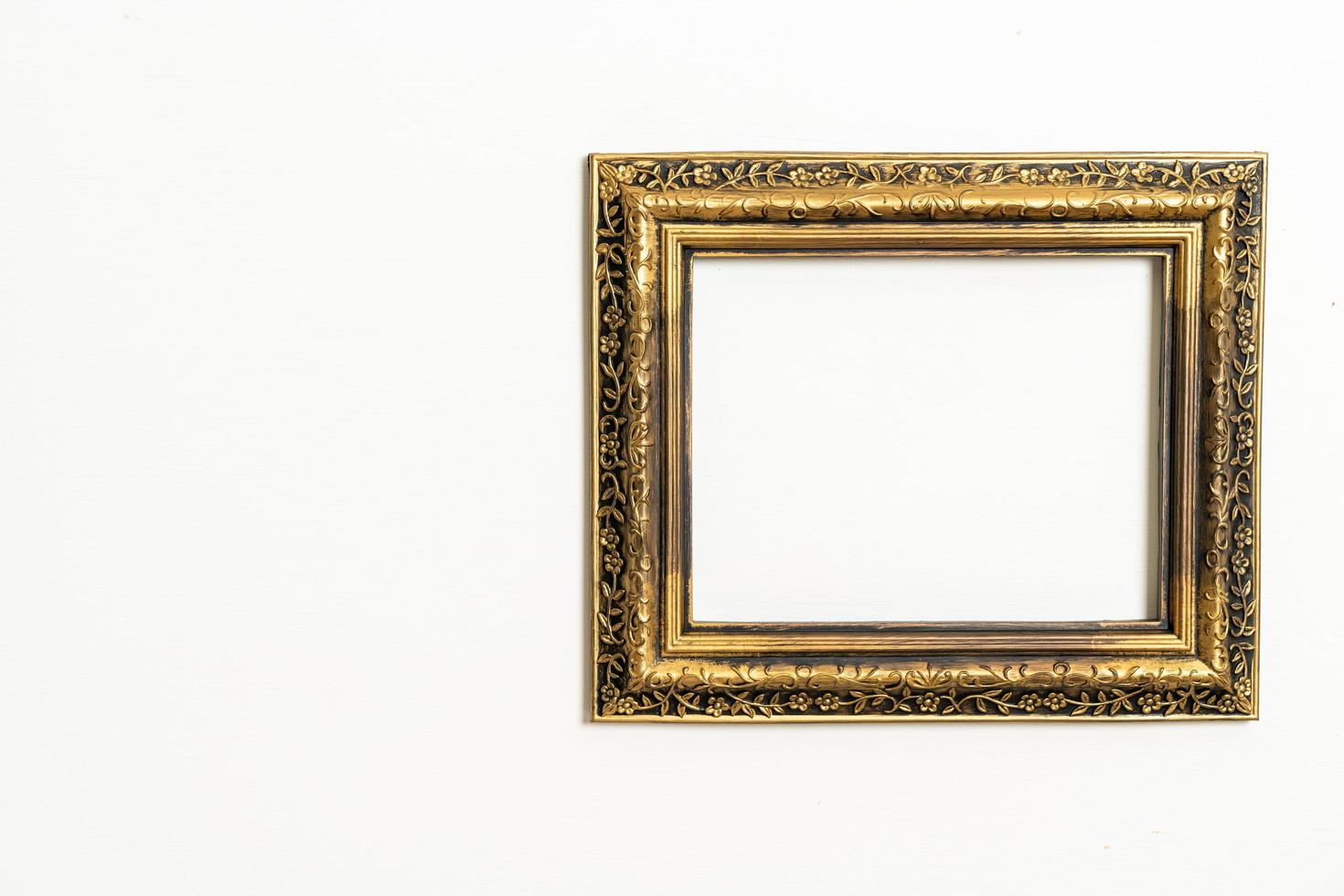 empty picture frame on white wall background photo