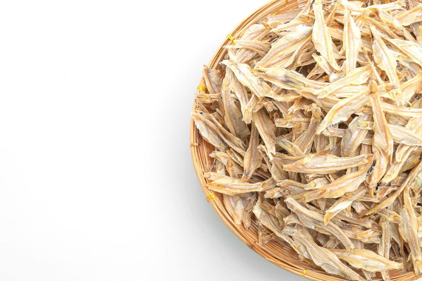 dried small crispy fish on white background photo