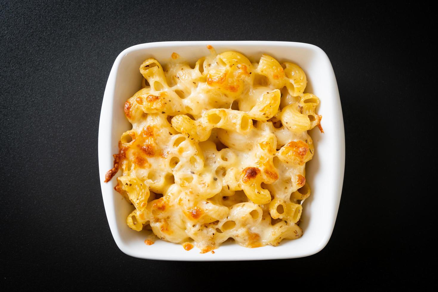 American mac and cheese, macaroni pasta in cheesy sauce photo