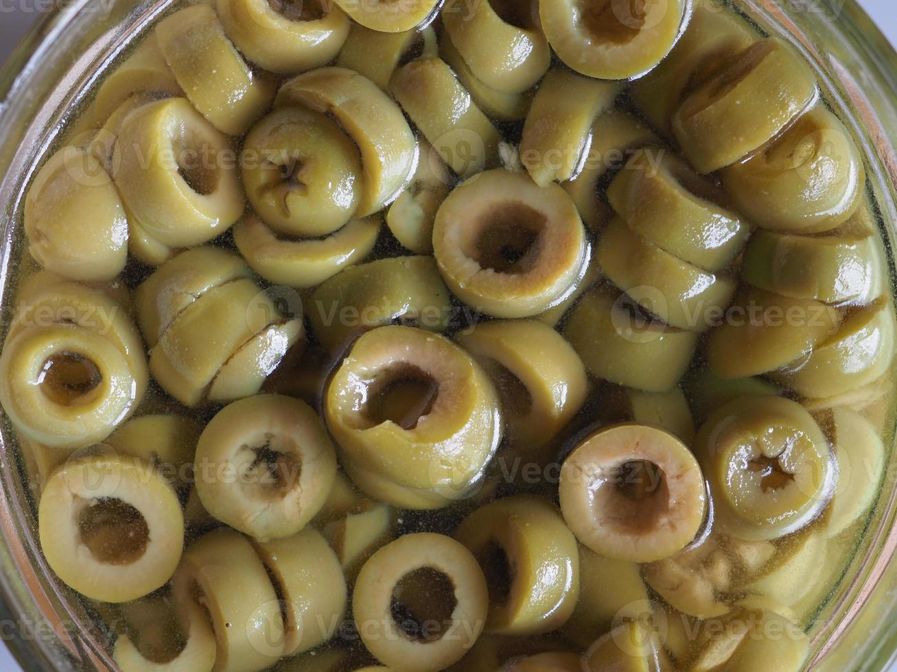 sliced green olives in brine background photo