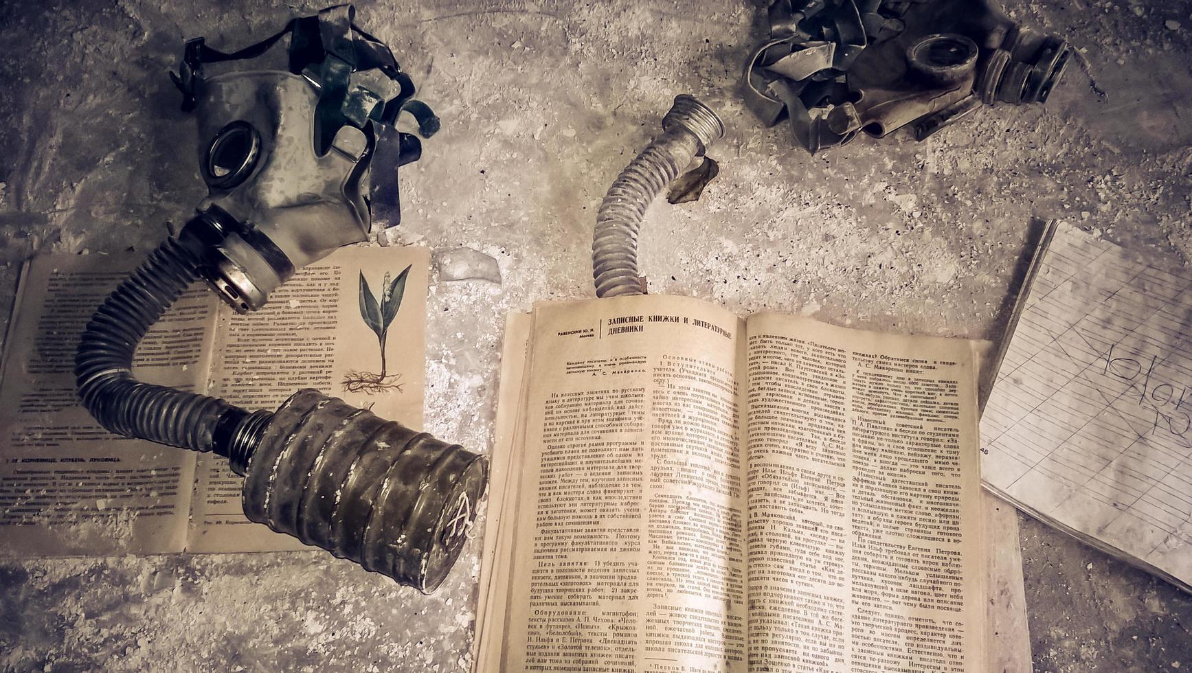 Pripyat, Ukraine, 2021 - Old books and gas masks in Chernobyl photo