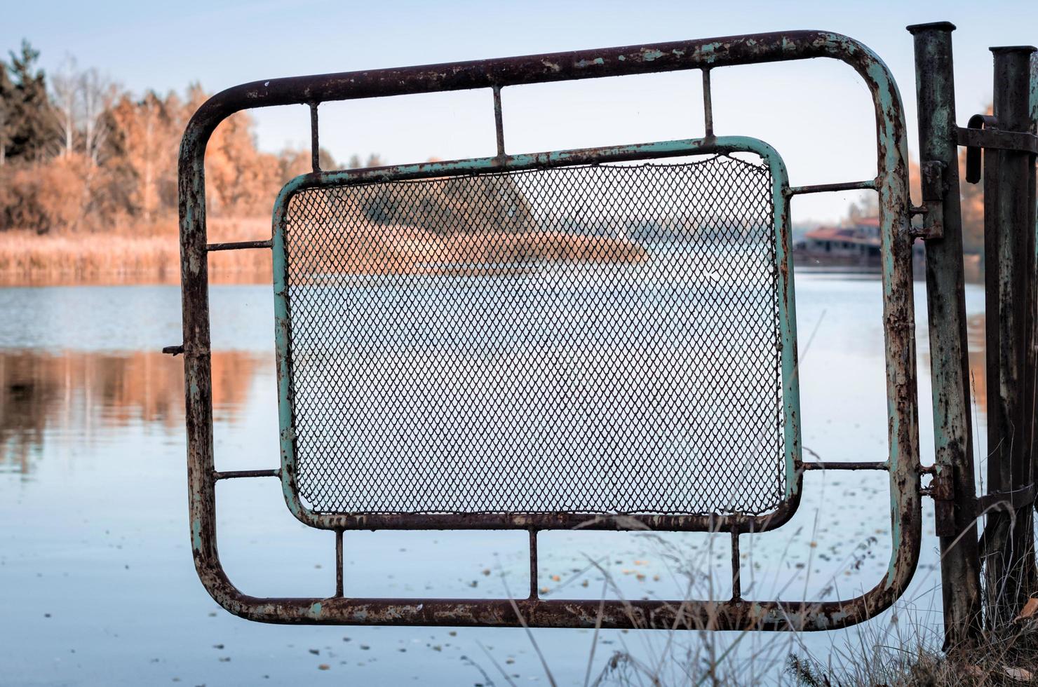 Pripyat, Ukraine, 2021 -Iron fence and river in Chernobyl photo