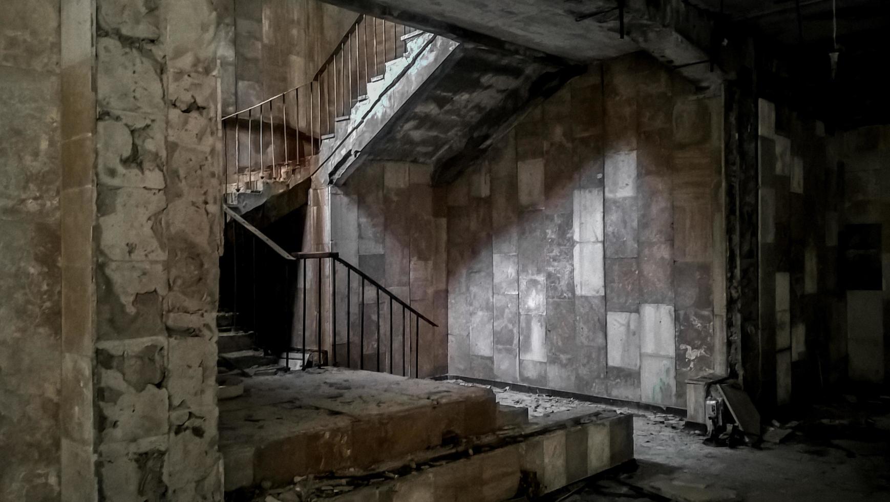 Pripyat, Ukraine, 2021 - Stone staircase inside an abandoned building in Chernobyl photo