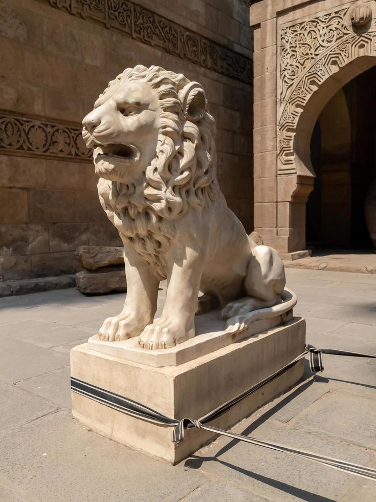 lion statue in front of the palace photo