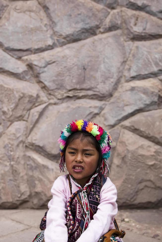 CUSCO, PERU, DECEMBER 31, 2017 - Unidentified girl on the street of Cusco, Peru. Almost 29 percent of Cusco population have less than 14 years. photo