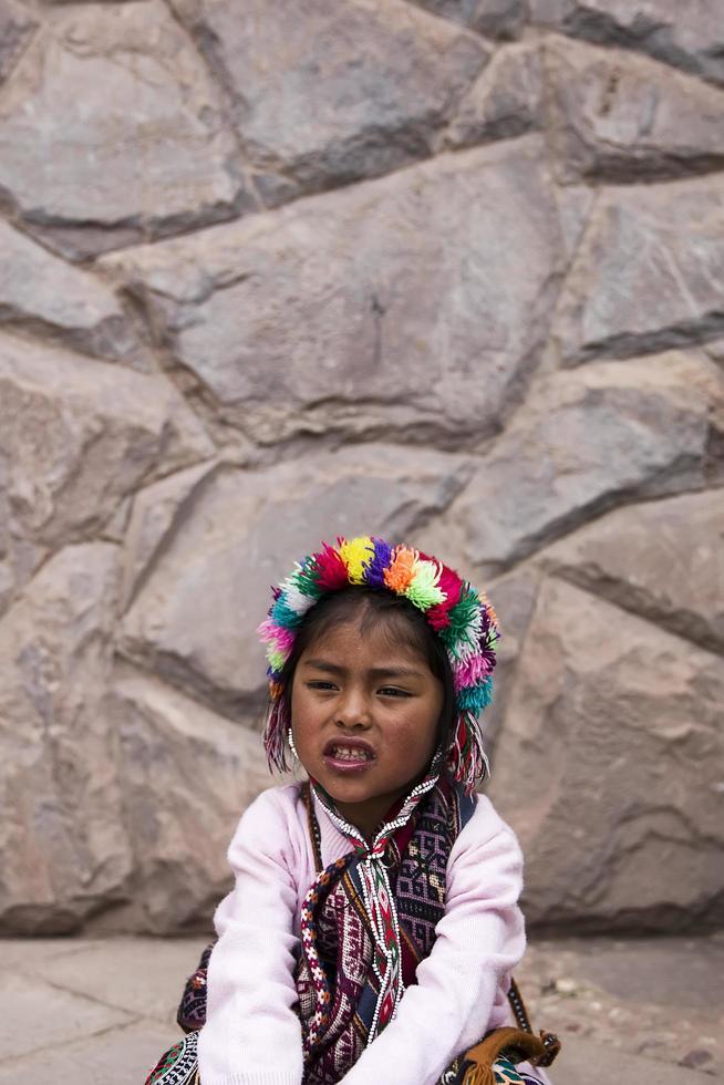 CUSCO, PERU, DECEMBER 31, 2017 - Unidentified girl on the street of Cusco, Peru. Almost 29 percent of Cusco population have less than 14 years. photo