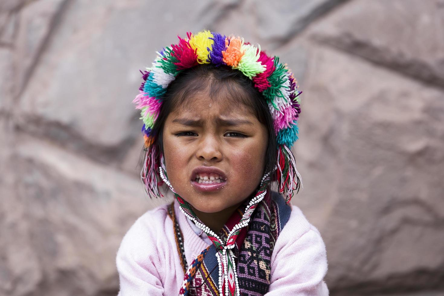 CUSCO, PERU, DECEMBER 31, 2017 - Unidentified girl on the street of Cusco, Peru. Almost 29 percent of Cusco population have less than 14 years. photo