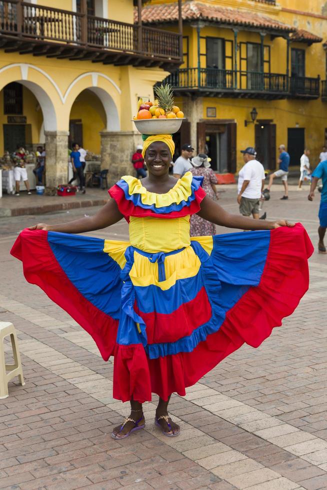 CARTAGENA, COLOMBIA, SEPTEMBER 16, 2019 - Unidentified palenquera, fruit seller lady on the street of Cartagena. These Afro-Colombian women come from village San Basilio de Palenque, outside the city. photo