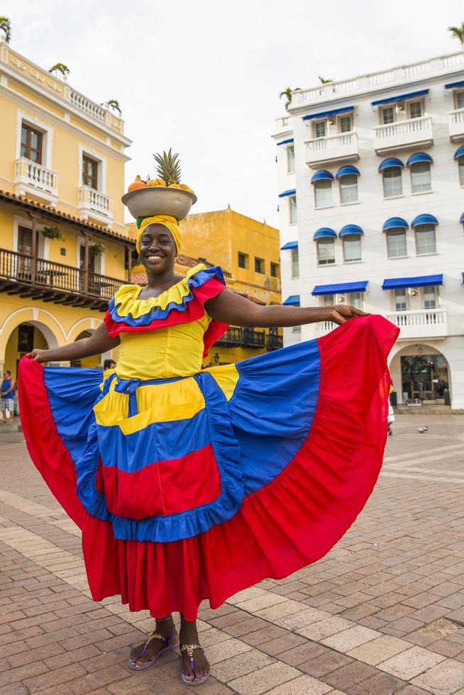 CARTAGENA, COLOMBIA, SEPTEMBER 16, 2019 - Unidentified palenquera, fruit seller lady on the street of Cartagena. These Afro-Colombian women come from village San Basilio de Palenque, outside the city. photo