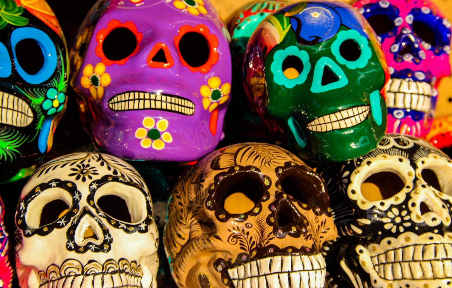 cabo san lucas, méxico, 8 de agosto de 2014 - calacas, cráneo de madera máscaras del día de los muertos en el mercado de cabo san lucas, méxico. las máscaras son símbolos típicos que representan calacas, esqueletos. foto