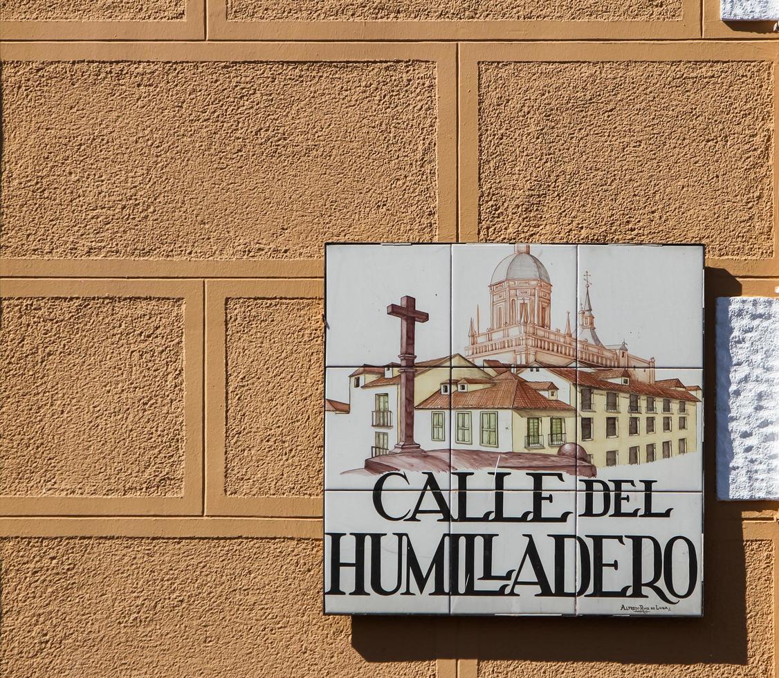 MADRID, SPAIN, MARCH 13, 2016 - Closeup of the street sign. Street signs in Madrid are hand-painted ceramic tiles typically composed within 9 or 12 tiles. They depict the name of the alley or street. photo
