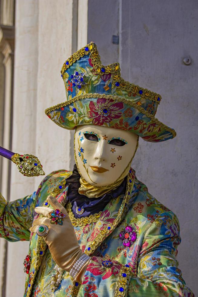 VENICE, ITALY, FEBRUARY 10, 2013 - Unidentified person with Venetian carnival mask in Venice, Italy. At 2013 it is held from January 26th to February 12th. photo