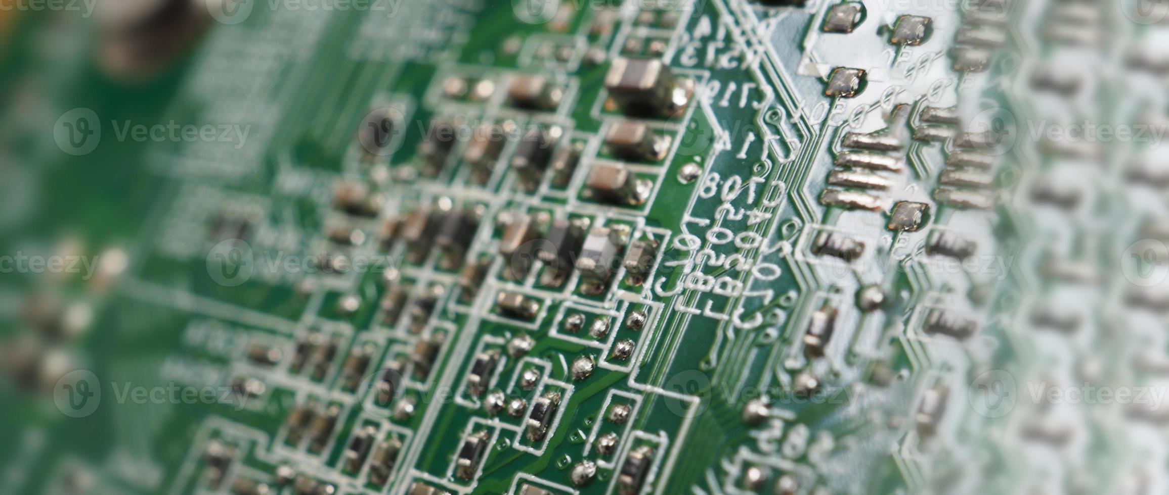 Semiconductor. cpu chip located on the green motherboard of the computer. photo
