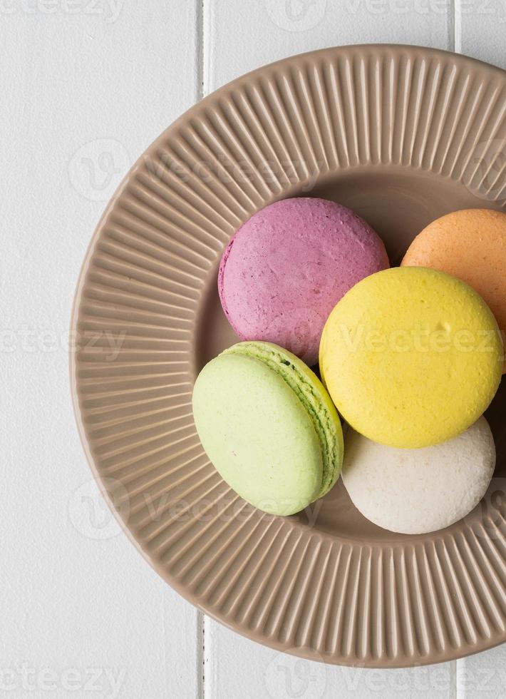 Flat lay macarons on the wooden table photo